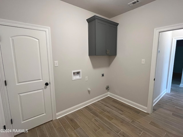 washroom with hookup for an electric dryer, dark hardwood / wood-style floors, gas dryer hookup, and washer hookup