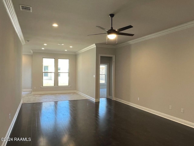 empty room with ceiling fan, dark hardwood / wood-style flooring, and crown molding