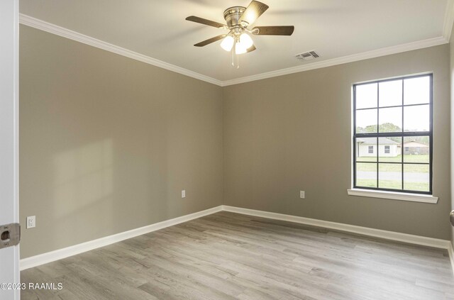 empty room with ornamental molding, light wood-type flooring, and ceiling fan