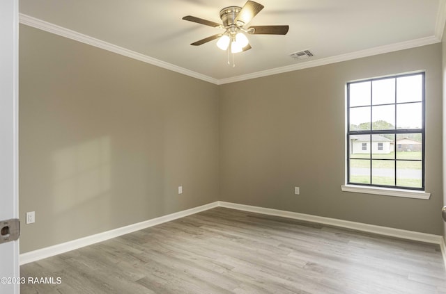 unfurnished room with a ceiling fan, wood finished floors, visible vents, baseboards, and ornamental molding