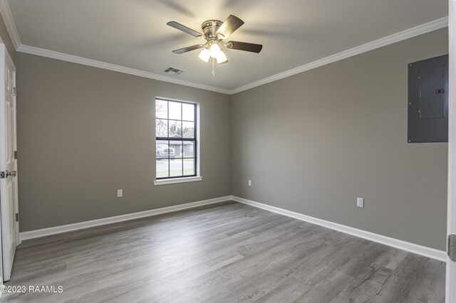 unfurnished room with hardwood / wood-style flooring, electric panel, and ceiling fan