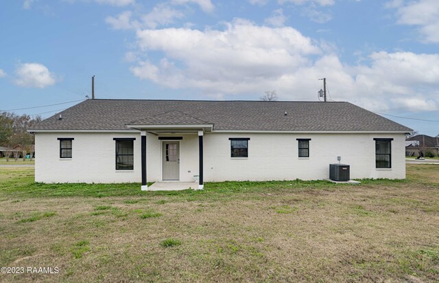 exterior space featuring central AC and a lawn