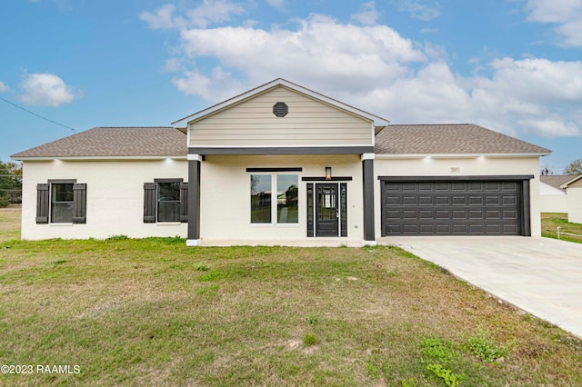 view of front of property featuring a garage and a front lawn