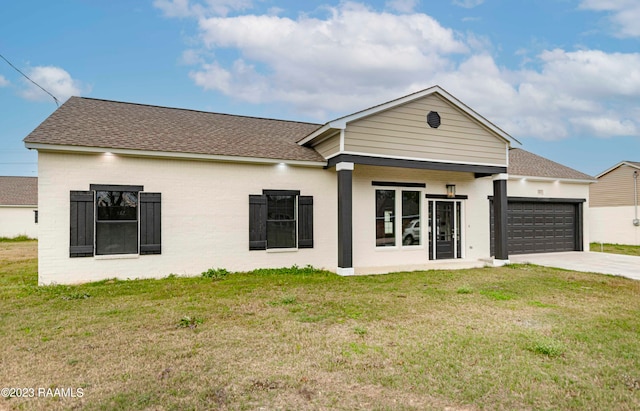 view of front of property with a garage and a front lawn