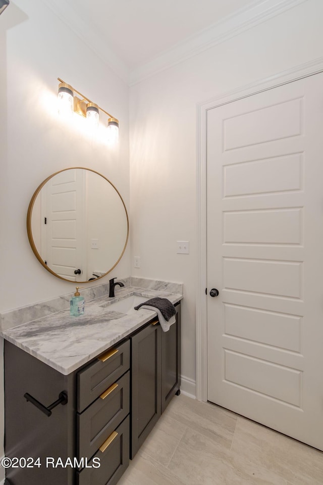 bathroom with tile patterned flooring, crown molding, and vanity