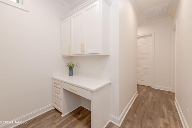 hallway with ornamental molding and hardwood / wood-style floors