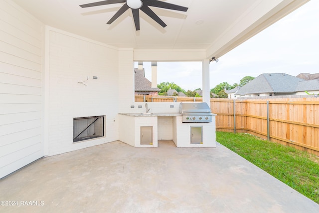 view of patio / terrace with an outdoor kitchen, sink, ceiling fan, and a grill