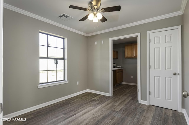 spare room featuring a wealth of natural light, crown molding, ceiling fan, and dark hardwood / wood-style floors