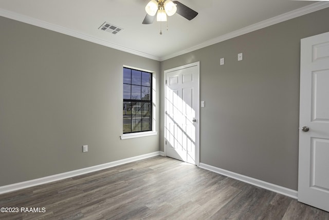 unfurnished room featuring hardwood / wood-style floors, ceiling fan, and crown molding