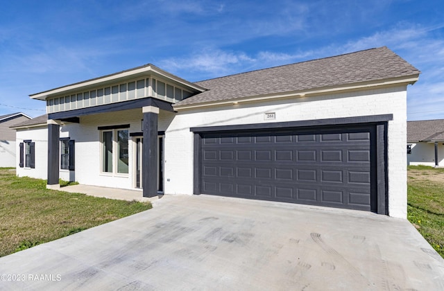 view of front of property with a front yard and a garage