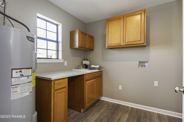 interior space with electric water heater, sink, and dark wood-type flooring