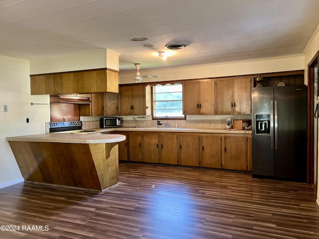 kitchen with stainless steel appliances, dark hardwood / wood-style floors, sink, and kitchen peninsula