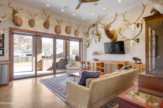 living room featuring ceiling fan and crown molding