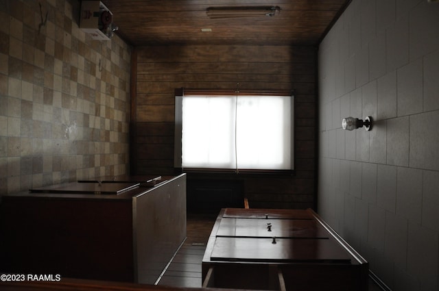 interior space with wooden ceiling and tile walls