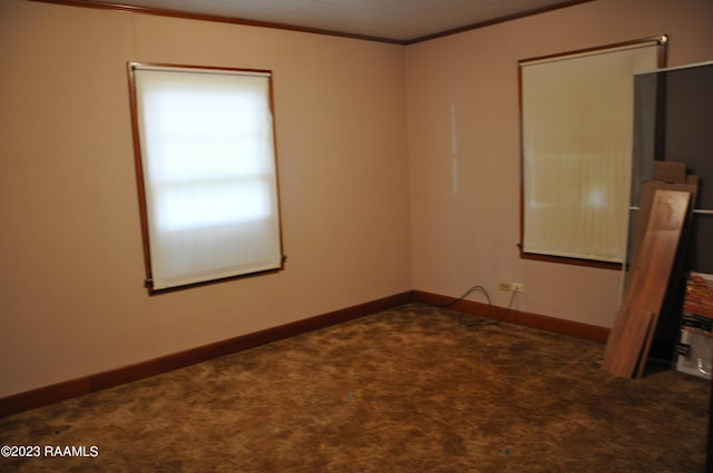 unfurnished room with baseboards, carpet floors, and ornamental molding
