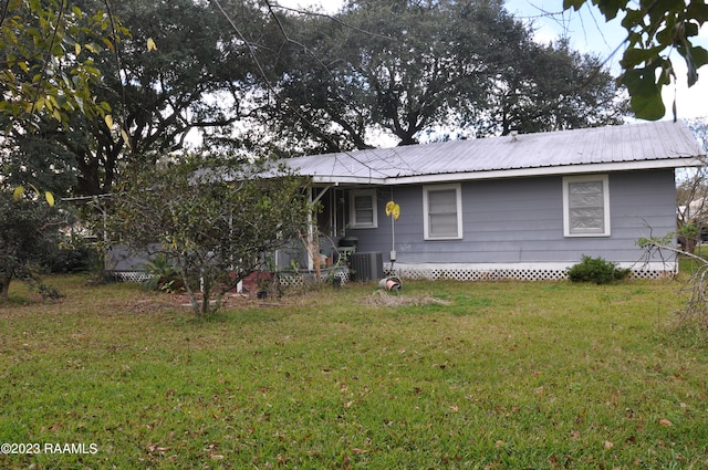 ranch-style home with a front yard and central AC