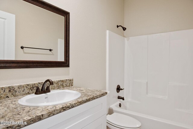 bathroom with shower / washtub combination, vanity, and toilet