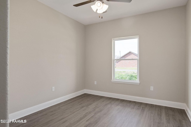 unfurnished room featuring dark wood-type flooring, baseboards, and a ceiling fan