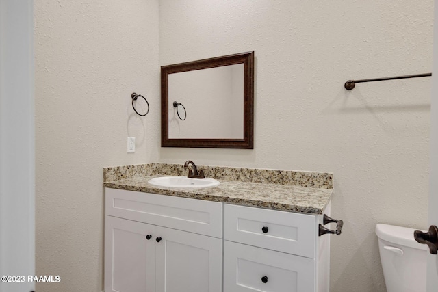 bathroom with toilet and vanity