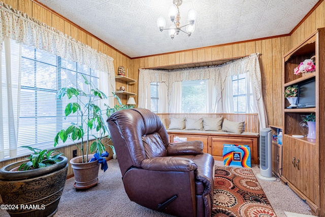 sitting room with light colored carpet, wood walls, a chandelier, and ornamental molding