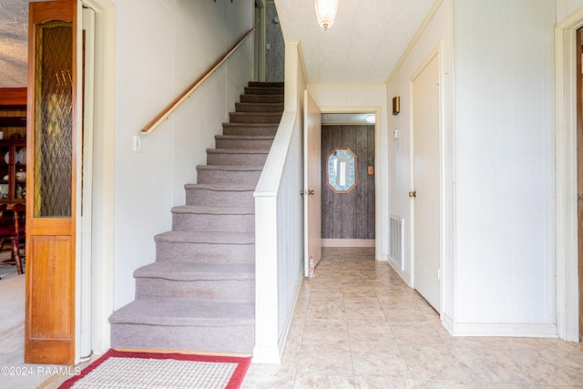 stairway featuring light tile flooring