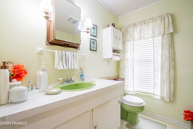 bathroom featuring tile flooring, oversized vanity, toilet, and a textured ceiling