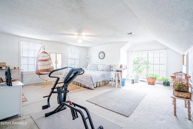 carpeted bedroom featuring a textured ceiling, ceiling fan, and vaulted ceiling