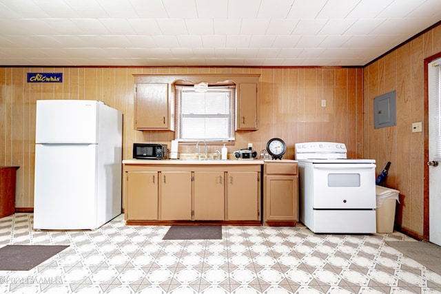 kitchen with white appliances, sink, light tile floors, and wooden walls