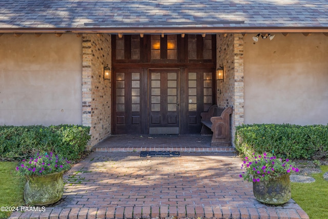 view of exterior entry with a porch