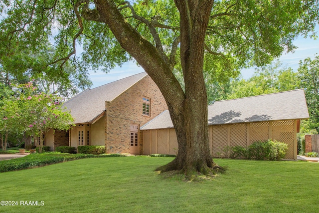 view of side of property featuring a yard