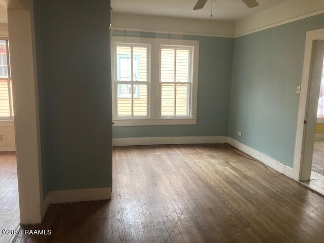 unfurnished room featuring ceiling fan, light wood-type flooring, and plenty of natural light