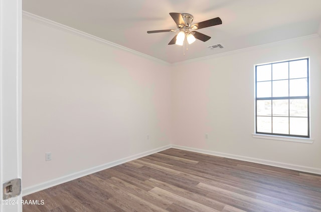 unfurnished room featuring dark hardwood / wood-style floors, ornamental molding, and ceiling fan