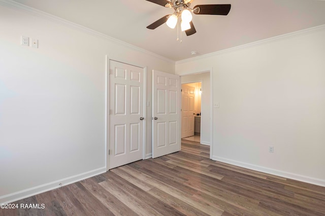 unfurnished bedroom with dark hardwood / wood-style floors, ornamental molding, and ceiling fan