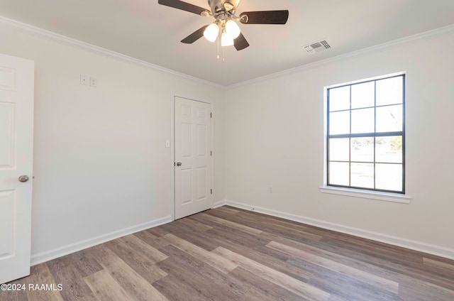 spare room featuring ceiling fan, crown molding, and dark hardwood / wood-style floors