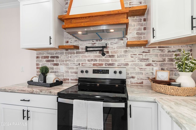 kitchen with white cabinets and electric range