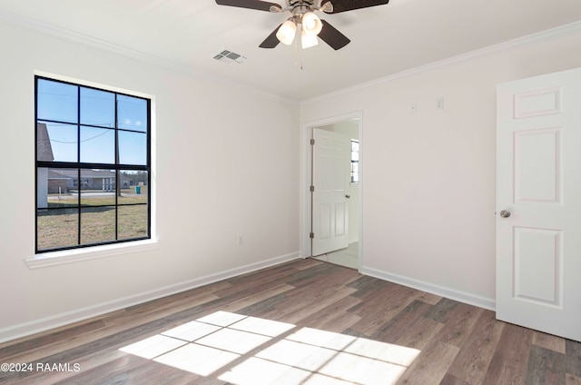 spare room with ceiling fan, crown molding, and light hardwood / wood-style floors