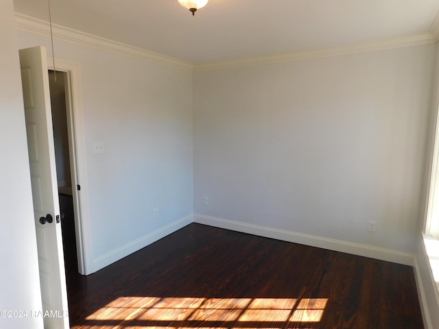 unfurnished room with crown molding and dark hardwood / wood-style flooring