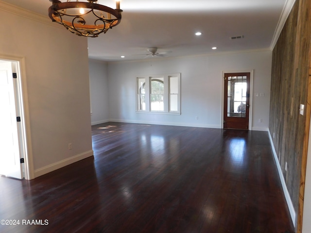 interior space featuring ornamental molding, dark hardwood / wood-style floors, and ceiling fan with notable chandelier