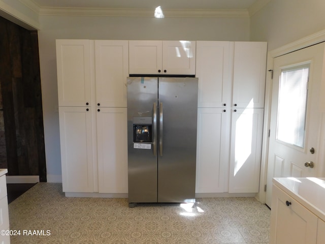 kitchen with light tile flooring, white cabinets, and stainless steel fridge