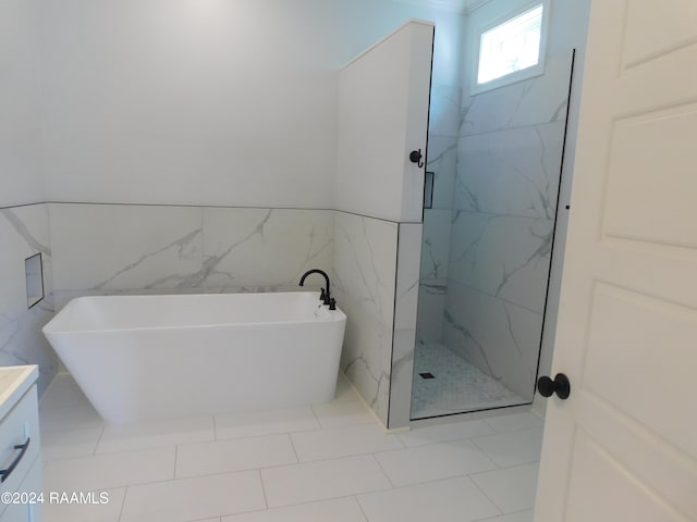 bathroom with tile walls, tile flooring, separate shower and tub, and vanity