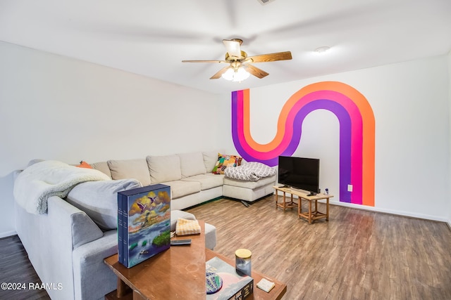 living room with dark hardwood / wood-style flooring and ceiling fan