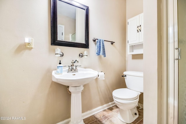 bathroom with tile floors and toilet