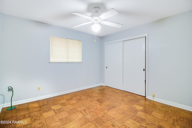 unfurnished bedroom with a closet, light parquet floors, and ceiling fan