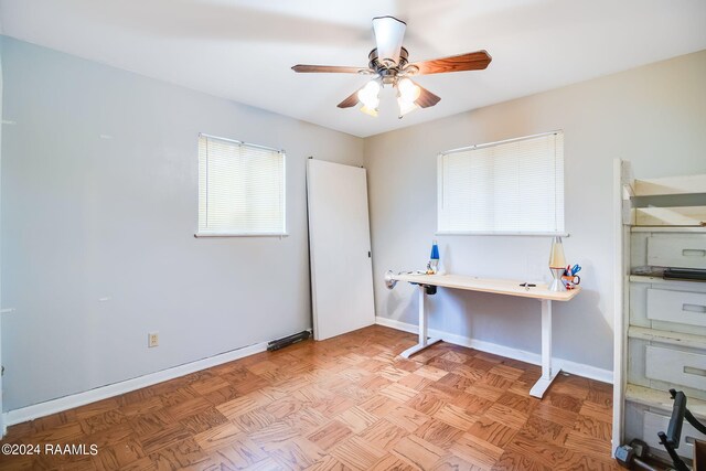 office featuring light parquet flooring and ceiling fan