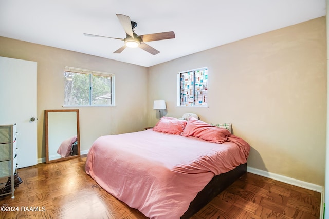 bedroom featuring ceiling fan and parquet flooring