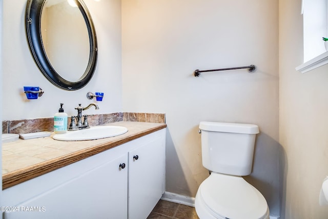 bathroom with oversized vanity, toilet, and tile floors