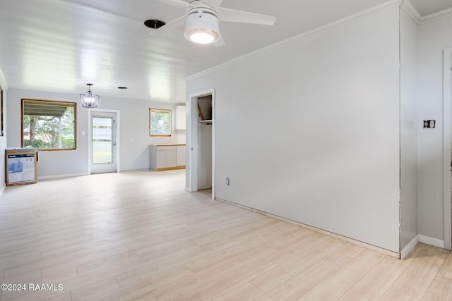 unfurnished room with ceiling fan, light wood-type flooring, and ornamental molding