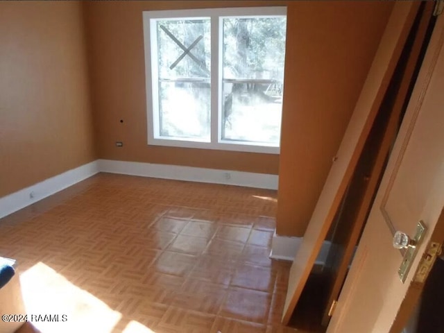 unfurnished room with light parquet floors