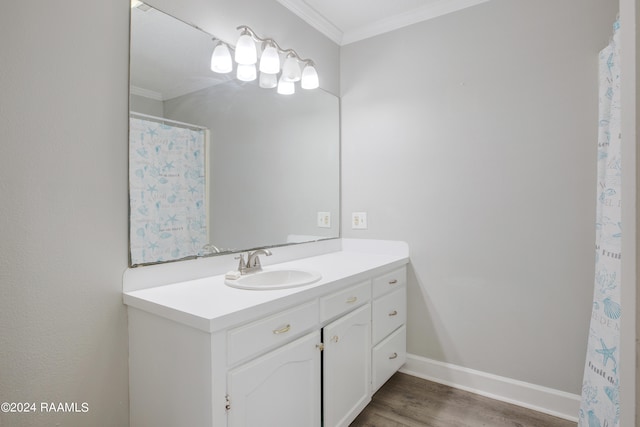 bathroom with crown molding, vanity, and wood-type flooring