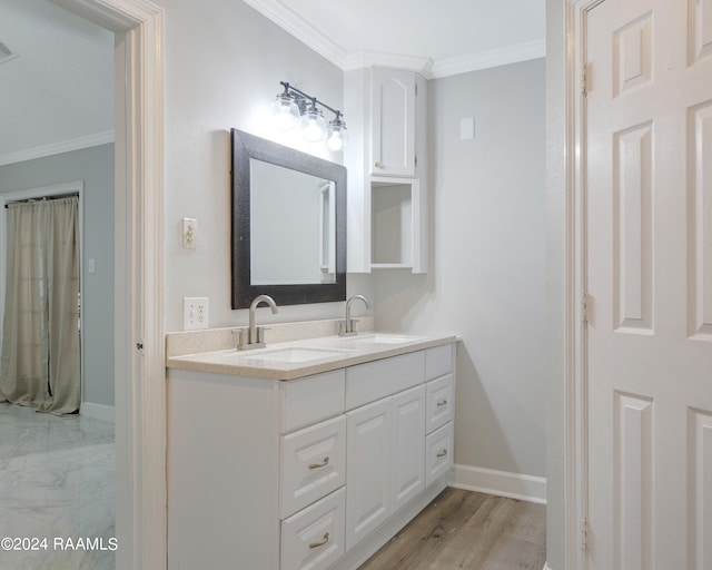 bathroom featuring crown molding, wood-type flooring, and double sink vanity